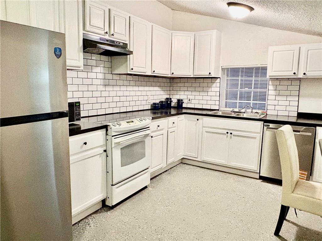 343 Cairo Street Northwest Atlanta, GA 30314 - Photo 4 of 13 a kitchen with granite countertop white cabinets and white appliances