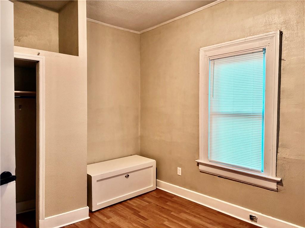 343 Cairo Street Northwest Atlanta, GA 30314 - Photo 8 of 13 a view of a small space with wooden floor and a window