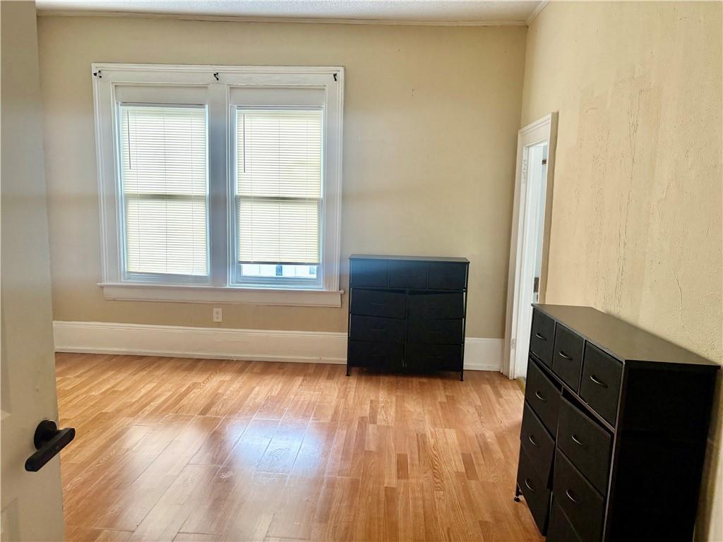 343 Cairo Street Northwest Atlanta, GA 30314 - Photo 10 of 13 an empty room with wooden floor and windows