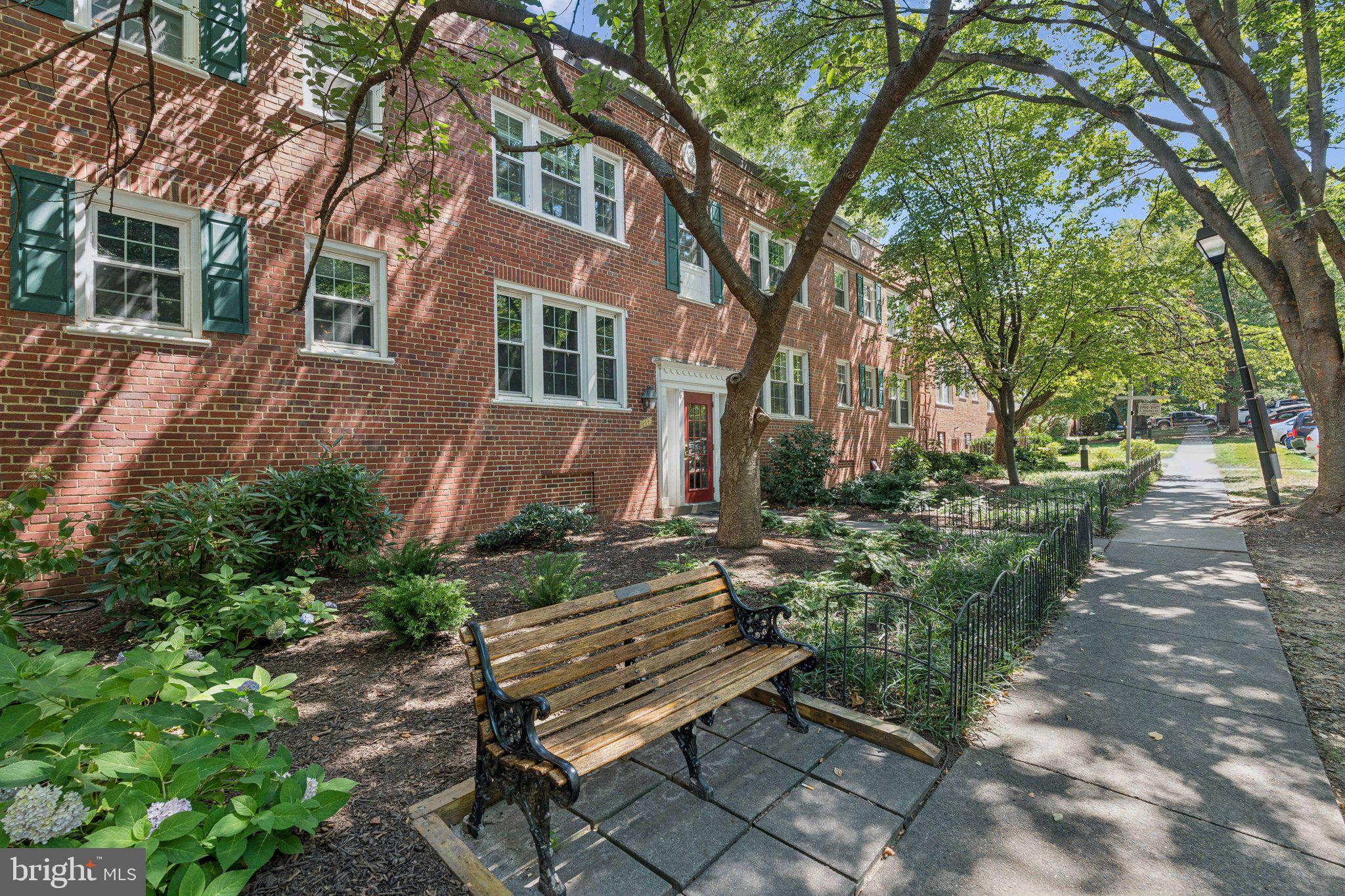 1909 North Rhodes Street, Unit 30 Arlington, VA 22201 - Photo 13 of 14 a view of a bench sitting in middle of yard