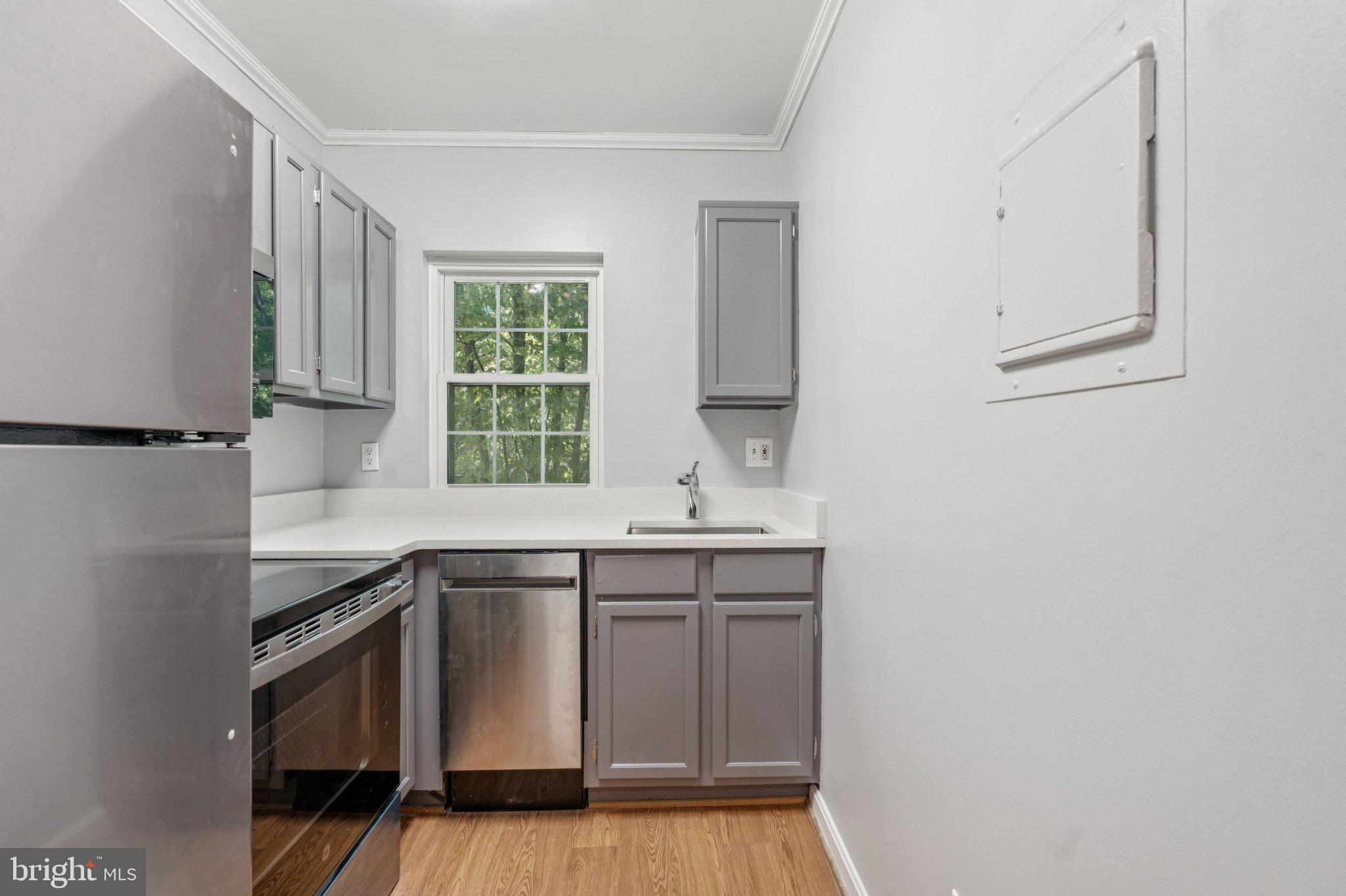 1909 North Rhodes Street, Unit 30 Arlington, VA 22201 - Photo 4 of 14 a kitchen with stainless steel appliances granite countertop a sink and a stove