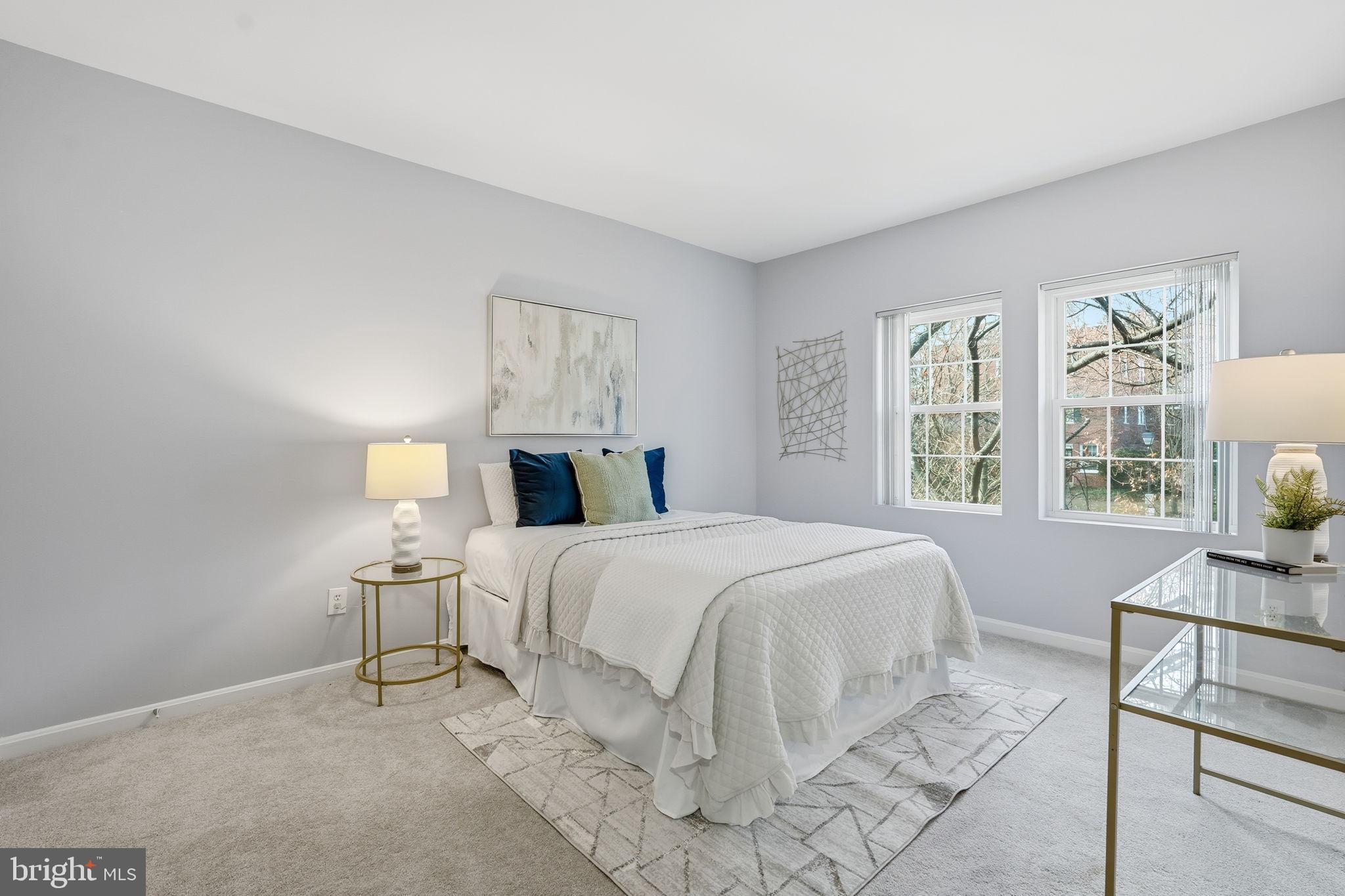 1909 North Rhodes Street, Unit 30 Arlington, VA 22201 - Photo 10 of 14 a bedroom with a bed and a table in it with window