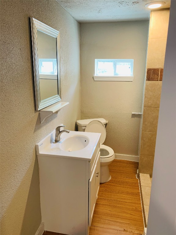 2304 South 1st Street, Unit C Austin, TX 78704 - Photo 12 of 26 a bathroom with a toilet sink and mirror