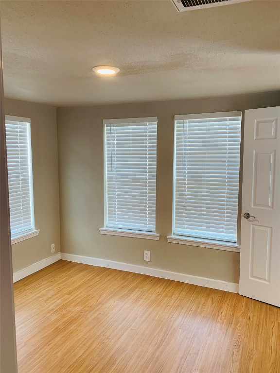 2304 South 1st Street, Unit C Austin, TX 78704 - Photo 15 of 26 an empty room with wooden floor and windows