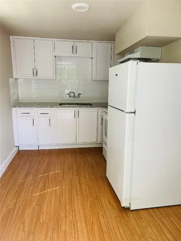 a white refrigerator freezer sitting inside of a kitchen