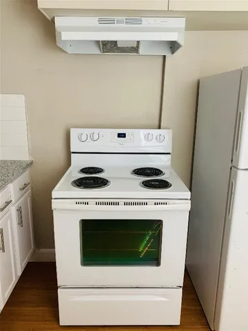 a stove top oven sitting inside of a kitchen