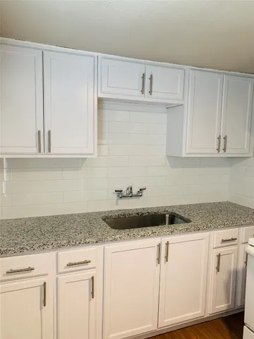 a kitchen with granite countertop white cabinets and a granite counter tops