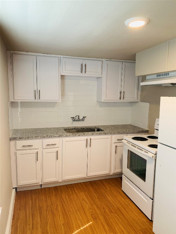 2304 South 1st Street, Unit C Austin, TX 78704 - Photo 20 of 26 a kitchen with granite countertop cabinets stainless steel appliances and wooden floor