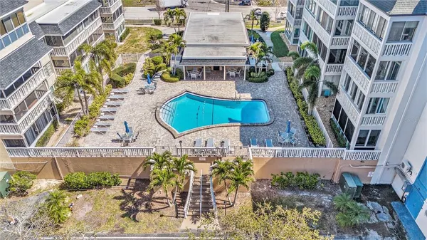 a view of a patio with couches table and chairs and potted plants