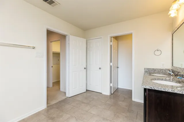 an empty room with a white wall and an entryway