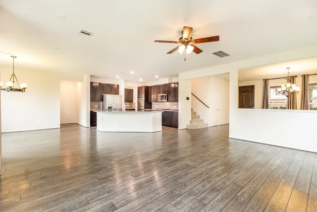 a view of a kitchen with wooden floor and a kitchen