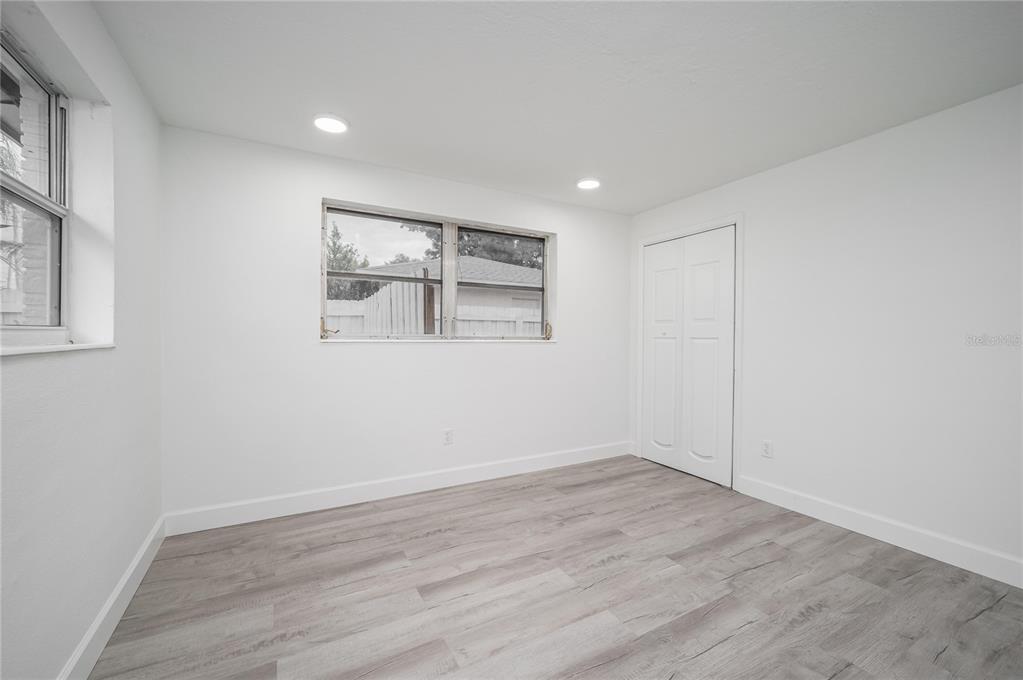 3409 Corey Road Sarasota, FL 34232 - Photo 13 of 19 wooden floor in an empty room with a window