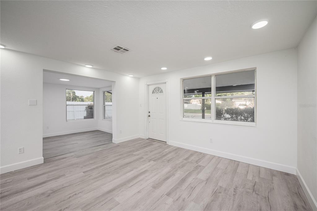 3409 Corey Road Sarasota, FL 34232 - Photo 5 of 19 an empty room with wooden floor and windows
