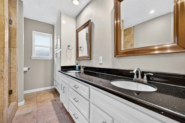 a bathroom with sinks and mirror
