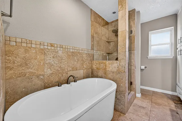 a bathroom with a bathtub and shower