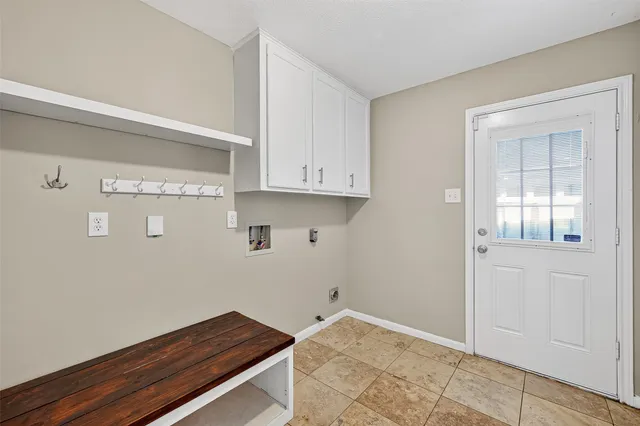 a room with wooden floor and cabinets