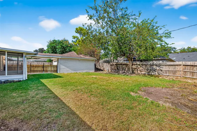 a view of a backyard with table and chairs and potted plants and big trees
