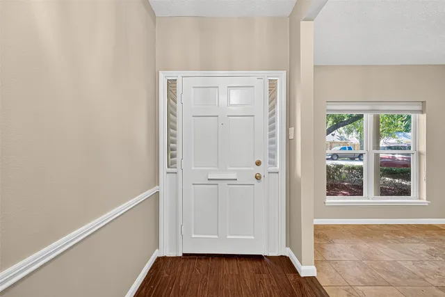 a view of front door with wooden floor