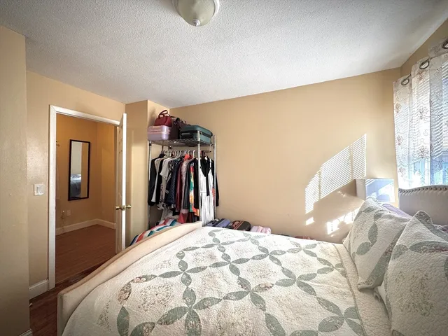 a view of a bedroom with a bed and a window