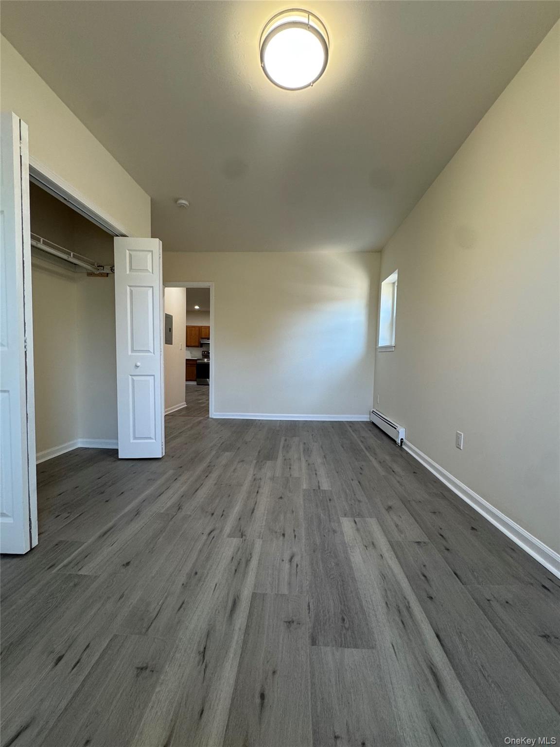167 Main Street, Unit 2 Beacon, NY 12508 - Photo 11 of 19 an empty room with wooden floor and windows