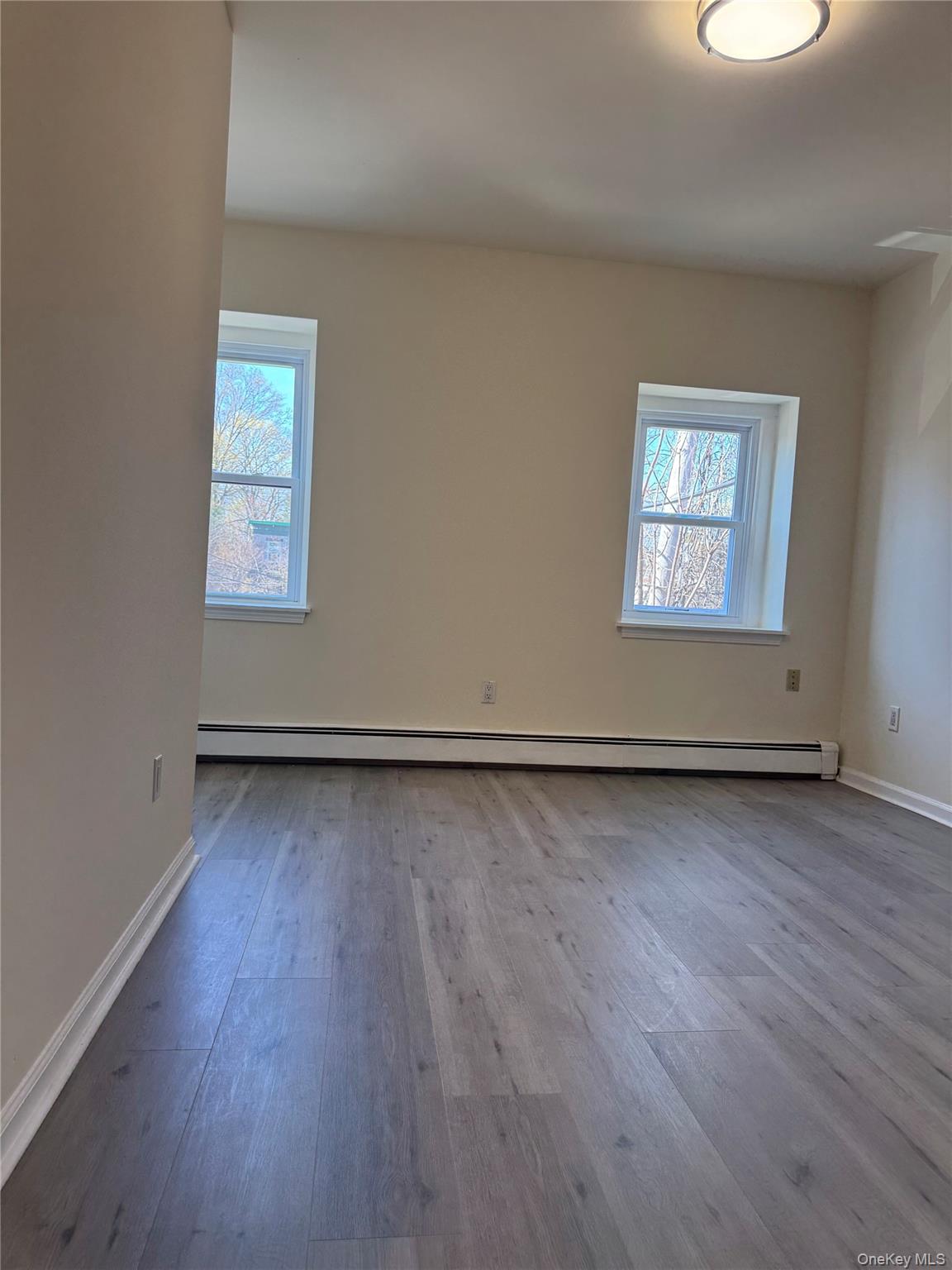 167 Main Street, Unit 2 Beacon, NY 12508 - Photo 14 of 19 an empty room with a hardwood and windows