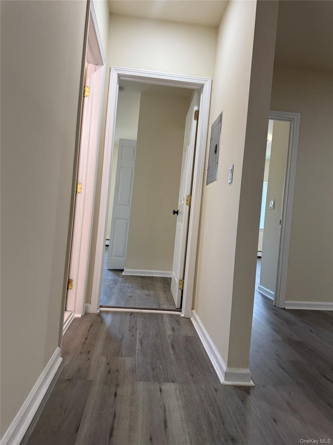 167 Main Street, Unit 2 Beacon, NY 12508 - Photo 17 of 19 an empty room with wooden floor and entrance