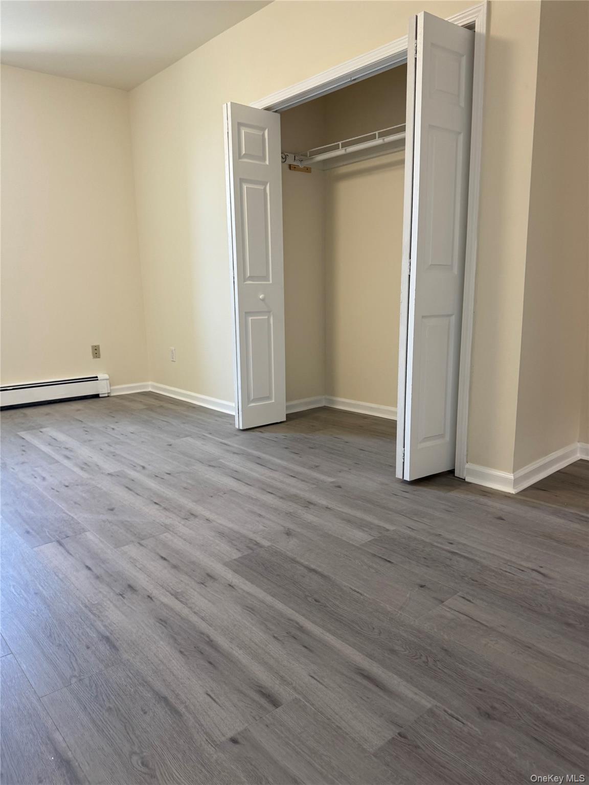 167 Main Street, Unit 2 Beacon, NY 12508 - Photo 8 of 19 an empty room with wooden floor and closet