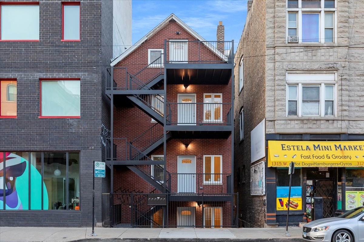 1313 West Chicago Avenue, Unit 3F Chicago, IL 60642 - Photo 1 of 16 a view of a brick building with large windows
