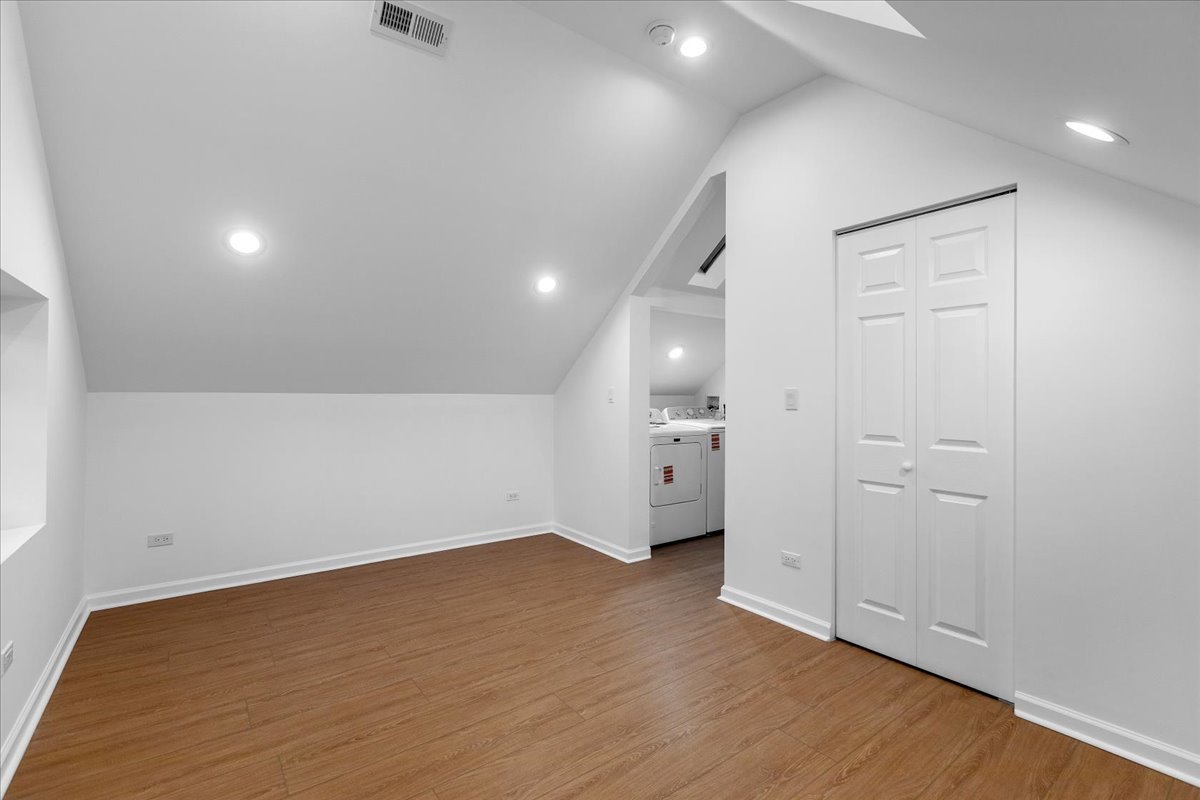 1313 West Chicago Avenue, Unit 3F Chicago, IL 60642 - Photo 11 of 16 wooden floor in an empty room with a window