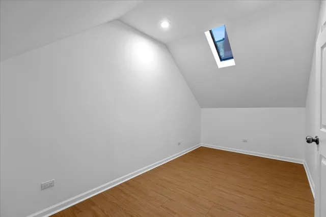 a view of a room with wooden floor and white walls