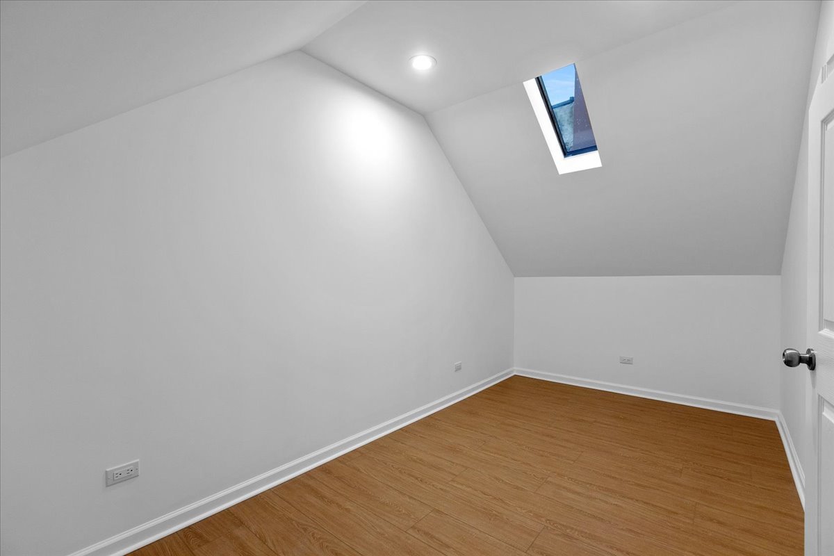 1313 West Chicago Avenue, Unit 3F Chicago, IL 60642 - Photo 14 of 16 a view of a room with wooden floor and white walls