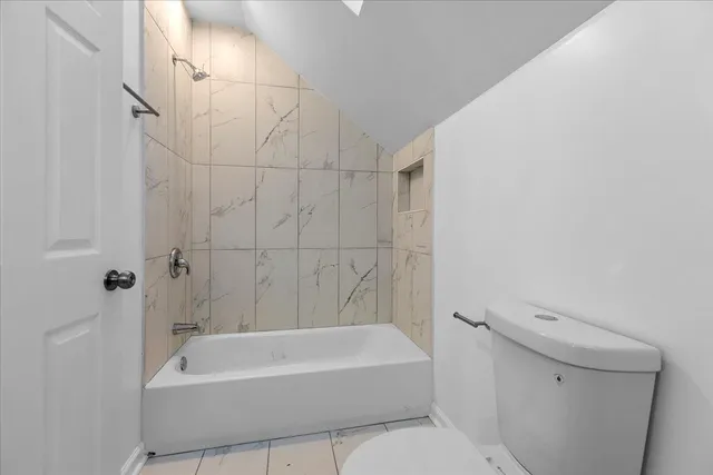 a bathroom with a bathtub a toilet and a shower