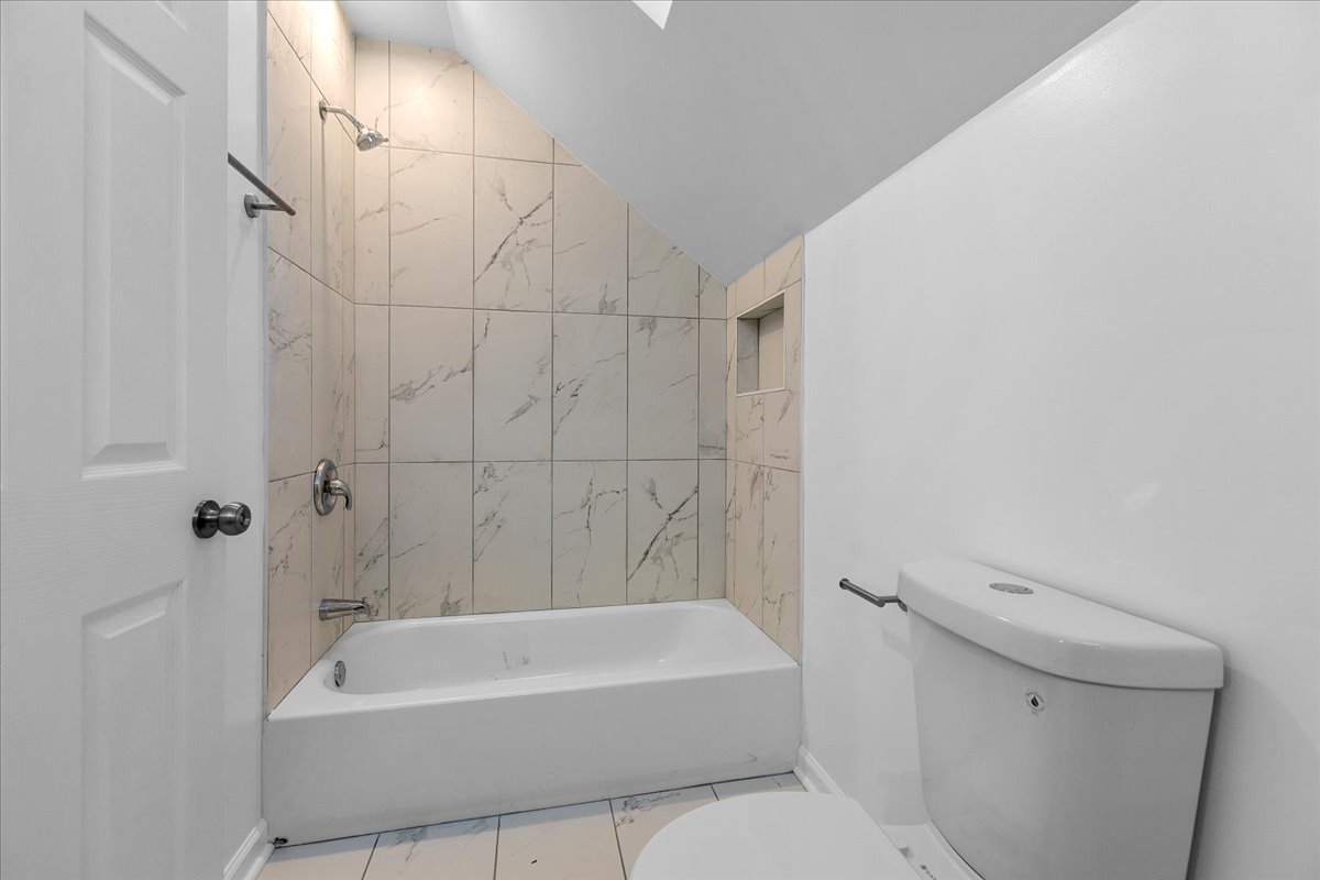 1313 West Chicago Avenue, Unit 3F Chicago, IL 60642 - Photo 16 of 16 a bathroom with a bathtub a toilet and a shower