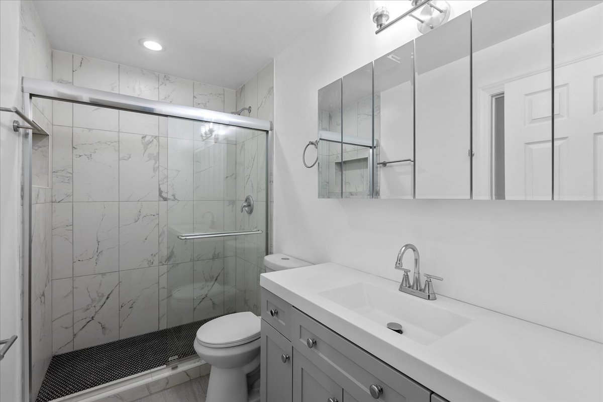 1313 West Chicago Avenue, Unit 3F Chicago, IL 60642 - Photo 9 of 16 a bathroom with a sink a toilet and shower