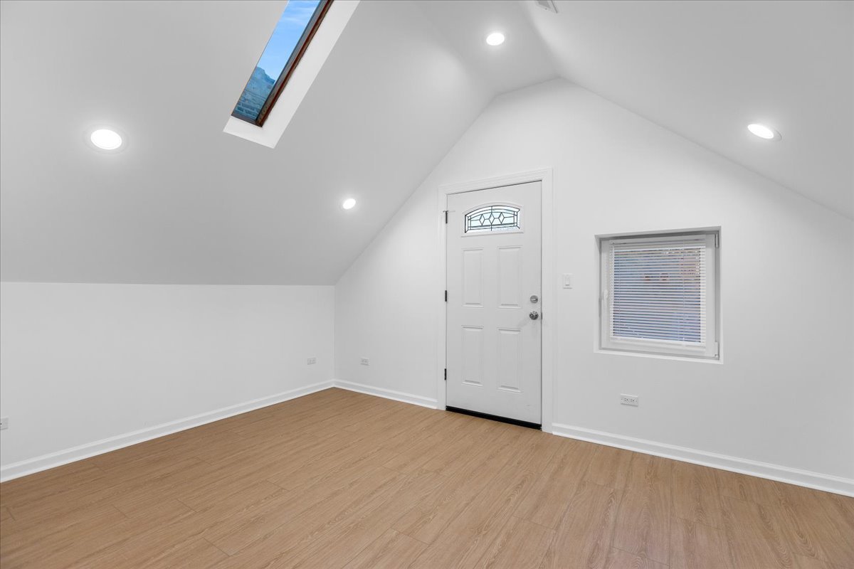 1313 West Chicago Avenue, Unit 3F Chicago, IL 60642 - Photo 10 of 16 an empty room with wooden floor and windows