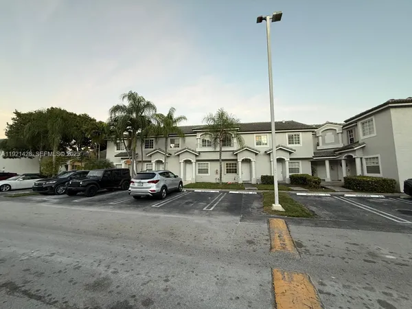 a view of city street with parked cars