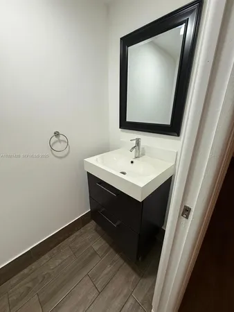 a bathroom with a sink vanity and a mirror