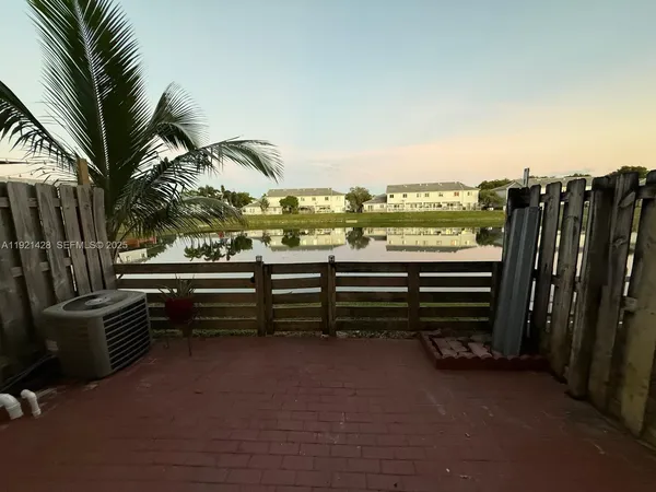 a view of a balcony with chairs and a swing