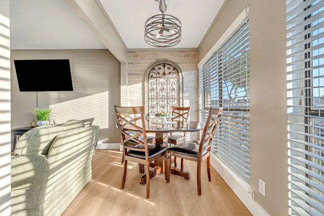 a view of a dining room with furniture window and wooden floor
