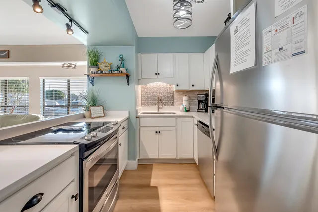 a kitchen with stainless steel appliances a refrigerator sink and stove