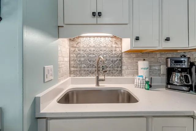 a kitchen with a sink and cabinets