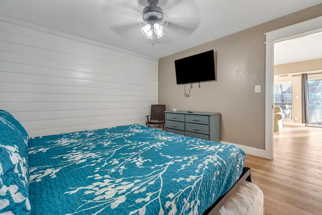 a bedroom with a bed and a flat screen tv