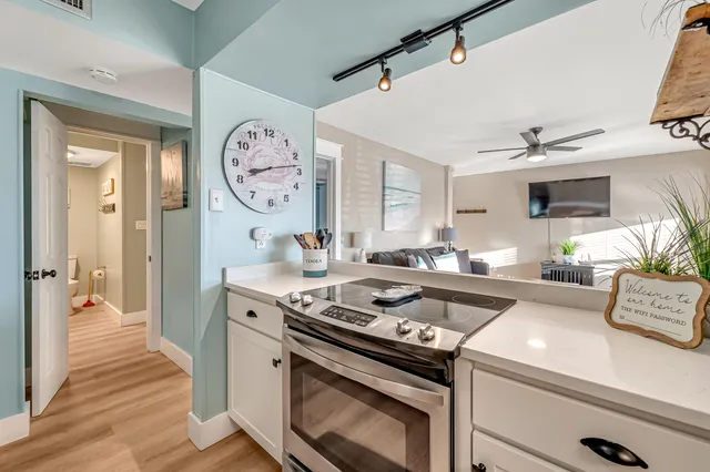 a kitchen with a stove and a clock