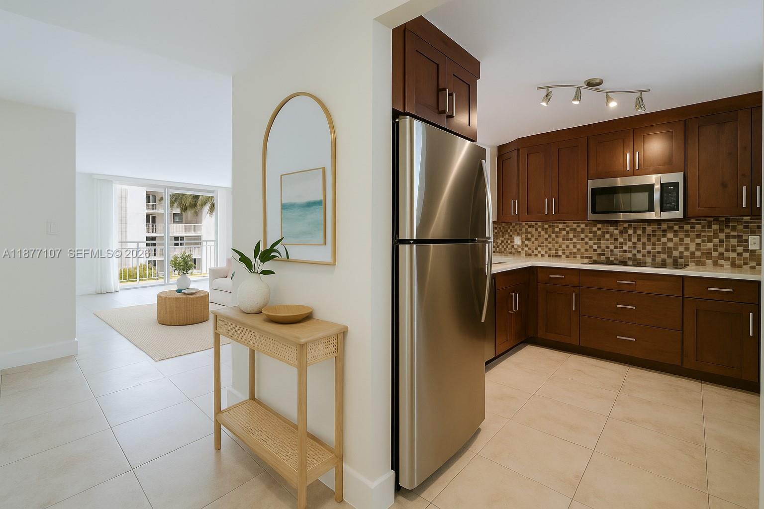 1665 Bay Road, Unit 521 Miami Beach, FL 33139 - Photo 4 of 25 a kitchen with stainless steel appliances a refrigerator a sink a stove and cabinets