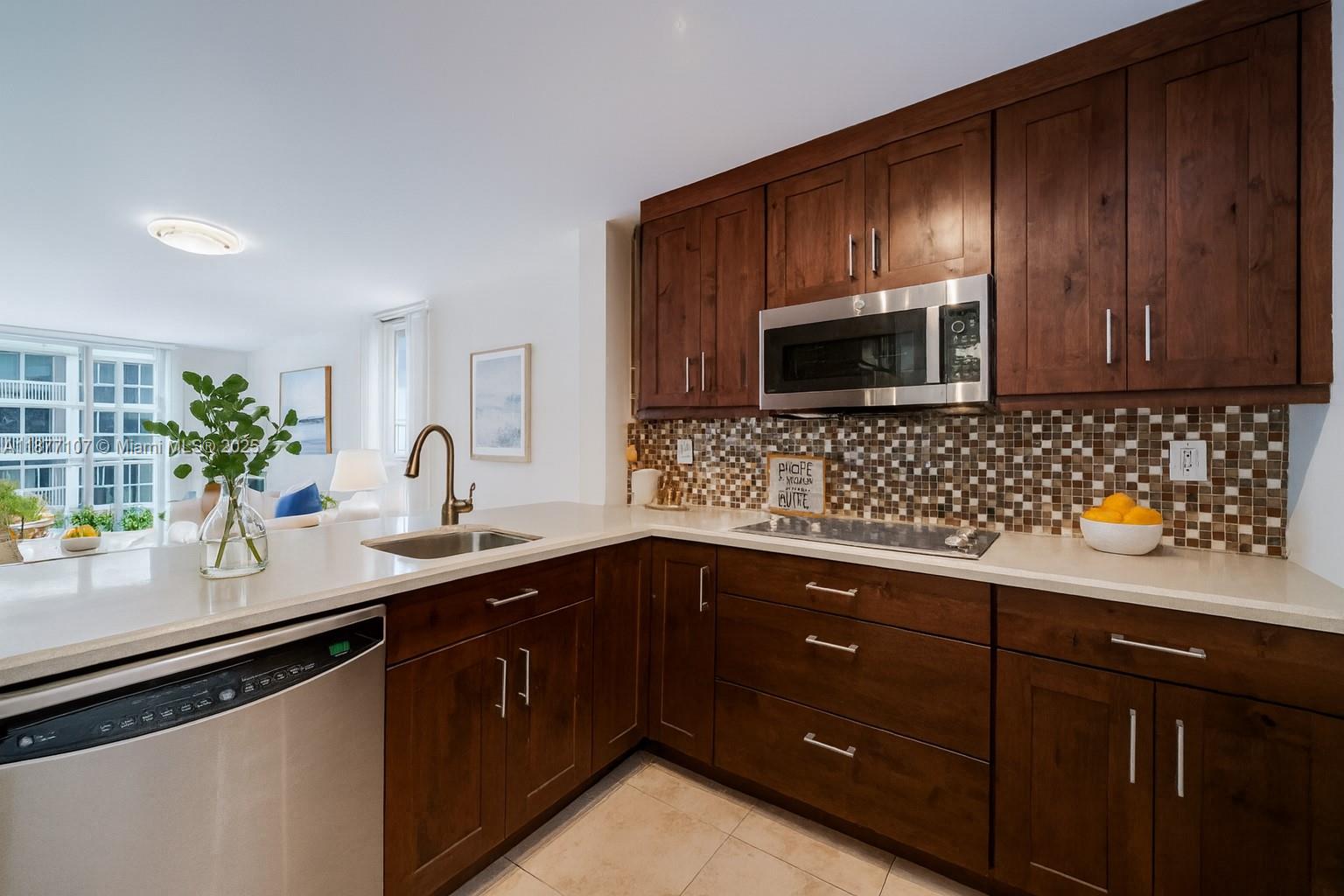 1665 Bay Road, Unit 521 Miami Beach, FL 33139 - Photo 5 of 25 a kitchen with sink and cabinets
