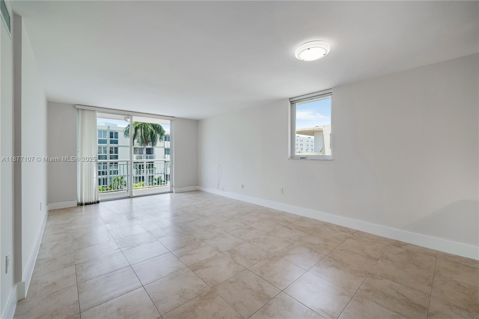 1665 Bay Road, Unit 521 Miami Beach, FL 33139 - Photo 6 of 25 an empty room with windows