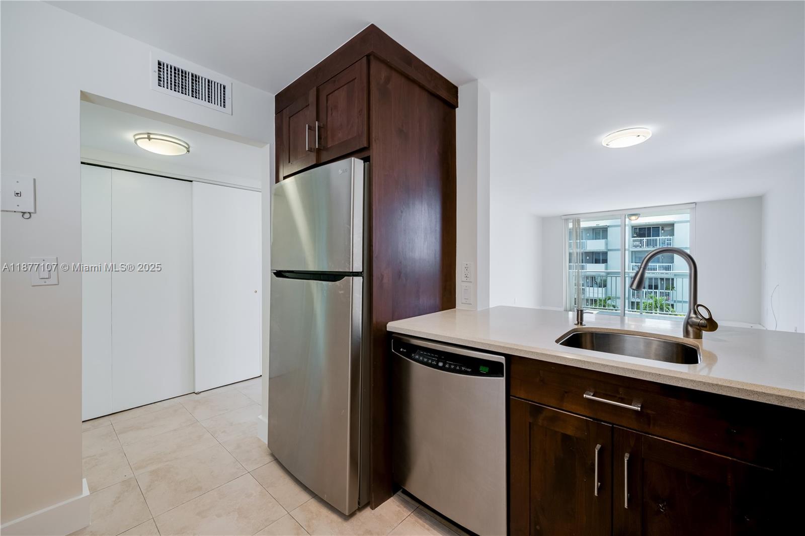 1665 Bay Road, Unit 521 Miami Beach, FL 33139 - Photo 7 of 25 a kitchen with a sink and refrigerator