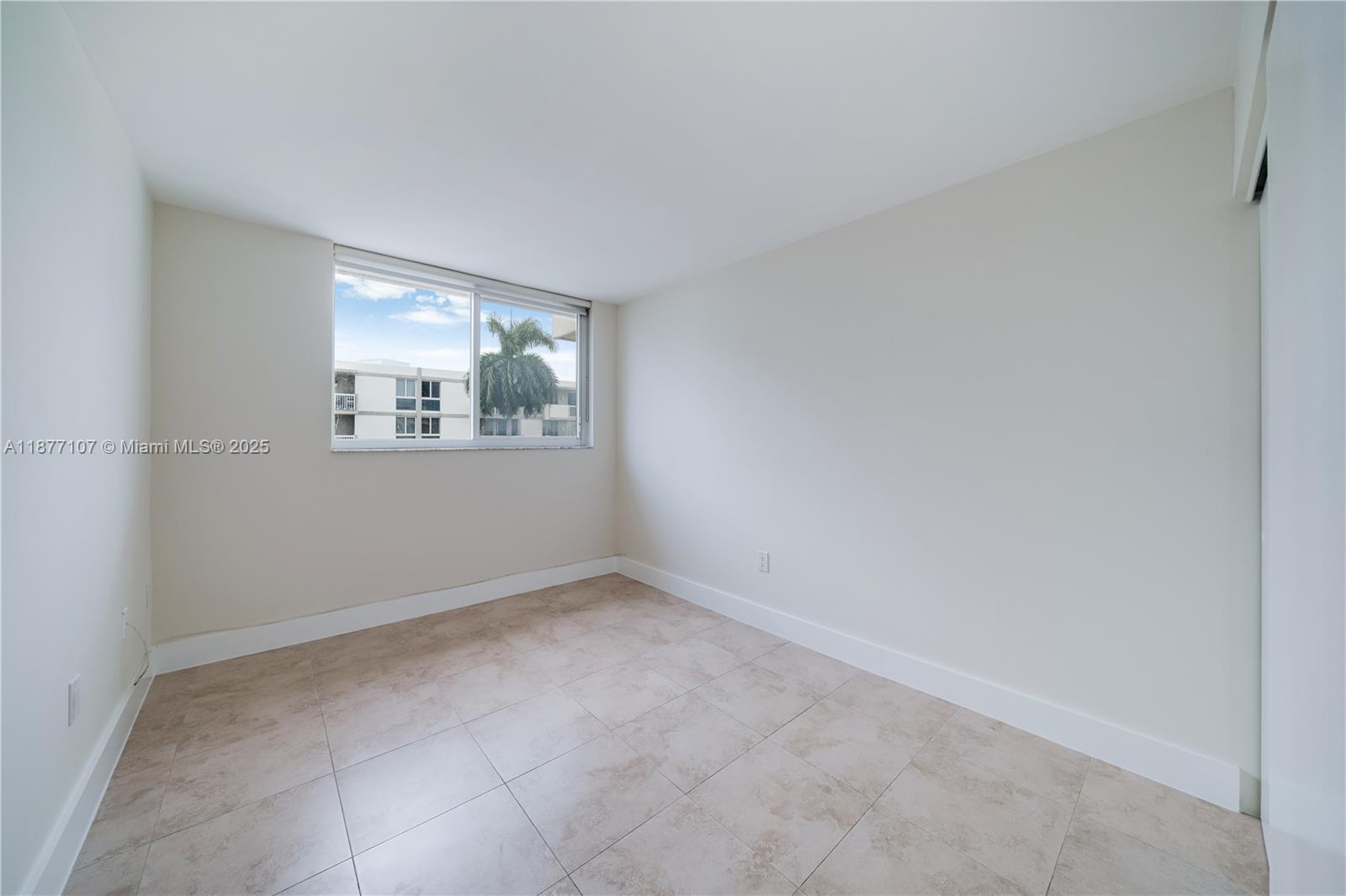 1665 Bay Road, Unit 521 Miami Beach, FL 33139 - Photo 9 of 25 an empty room with windows