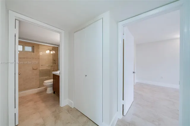 a bathroom with a sink toilet a mirror and shower