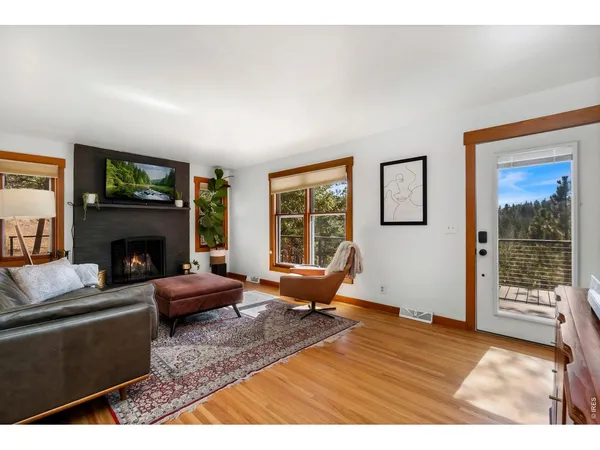a living room with furniture wooden floor and a fireplace
